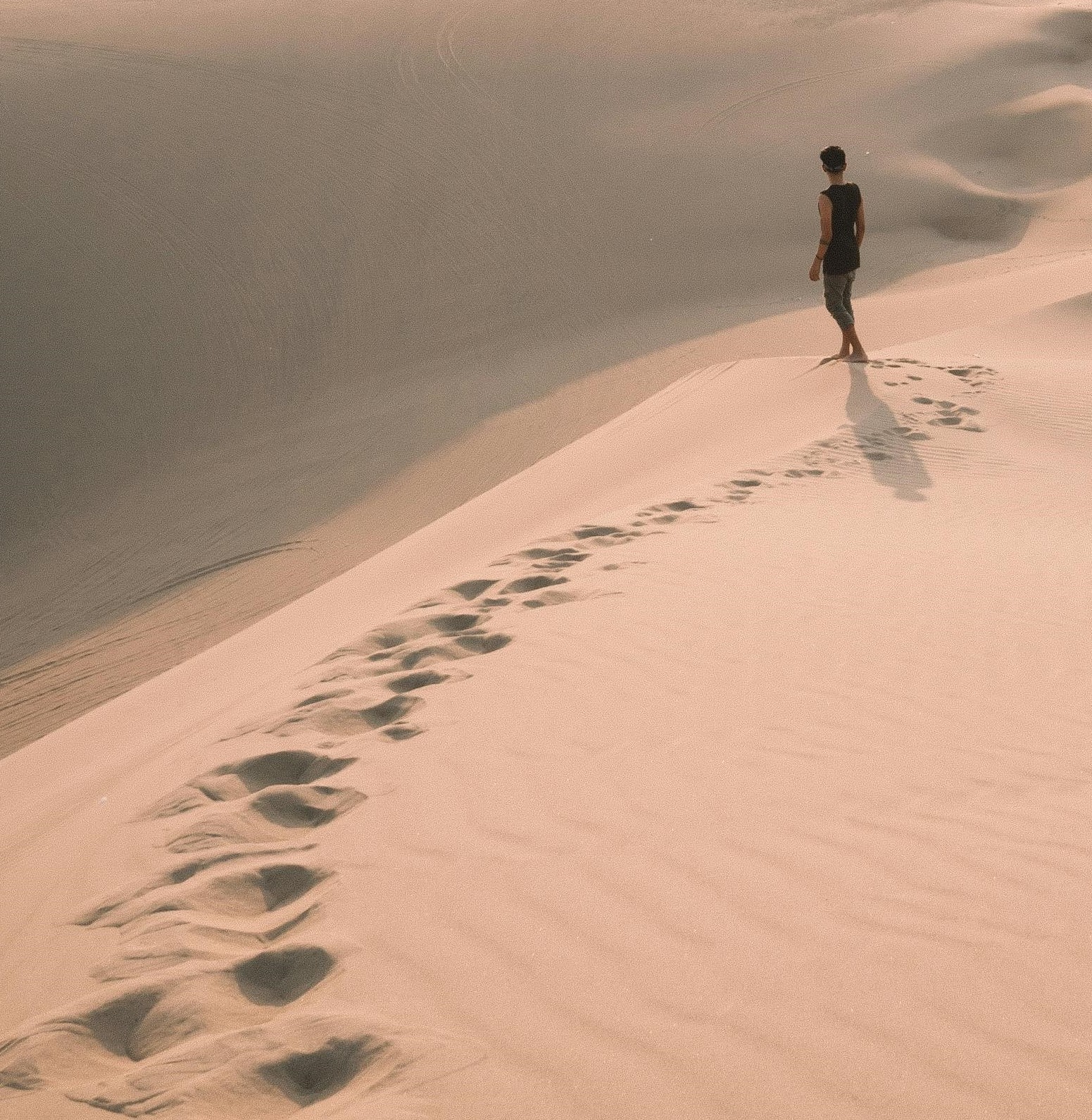 image person walking on sand
